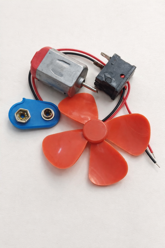 Small fan DIY kit with motor, battery connector, propeller, button and LED.